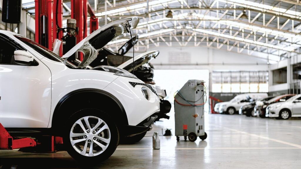 Vehicles waiting for repair at a dealership service center.